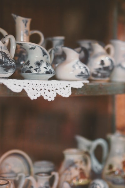 White and black ceramic pot flowers on display
